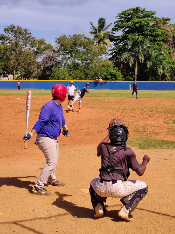 An exciting amateur baseball game with players in action on a sunny day, perfect for sports enthusiasts.